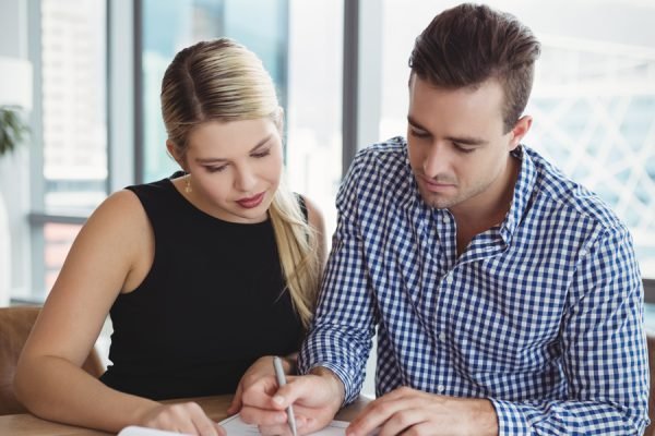executives-discussing-over-paper-at-desk-2021-08-28-16-45-12-utc.jpg
